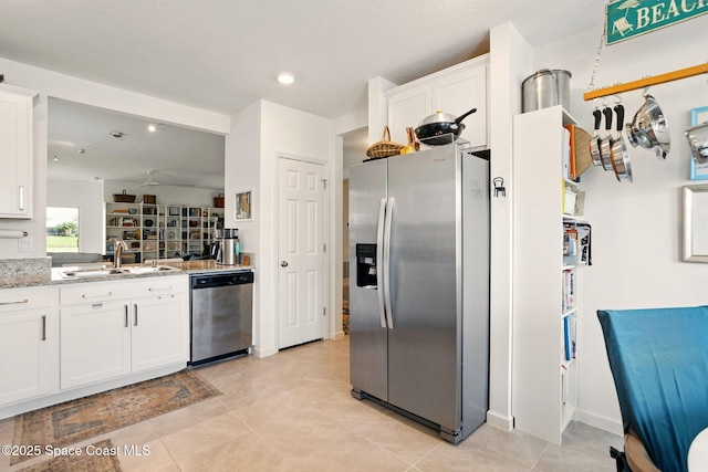 3547 Aberdeen Dr SE, Palm Bay, FL 32909 - kitchen featuring appliances with stainless steel finishes, a sink, white cabinets, light stone countertops, and recessed lighting