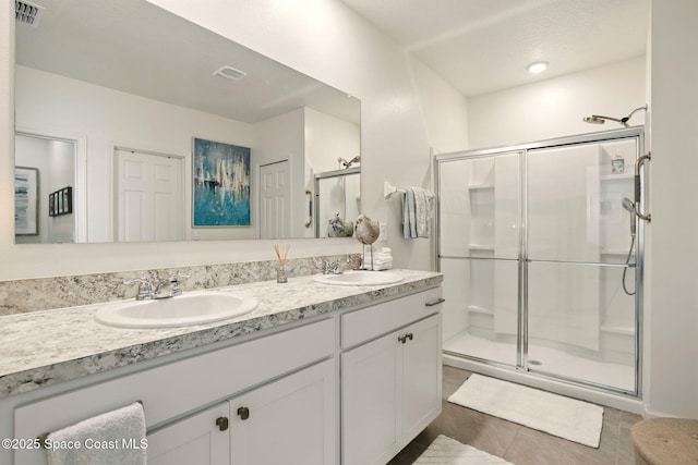 3547 Aberdeen Dr SE, Palm Bay, FL 32909 - full bath with double vanity, a stall shower, and tile patterned flooring