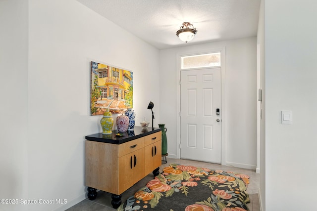 3547 Aberdeen Dr SE, Palm Bay, FL 32909 - entrance foyer featuring light tile patterned floors, baseboards, and a textured ceiling