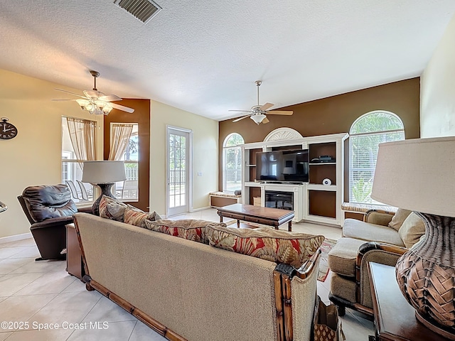 2050 SE Ellington Ter, Port St Lucie, FL 34952 - living area with ceiling fan, healthy amount of natural light, light tile patterned flooring, and a textured ceiling