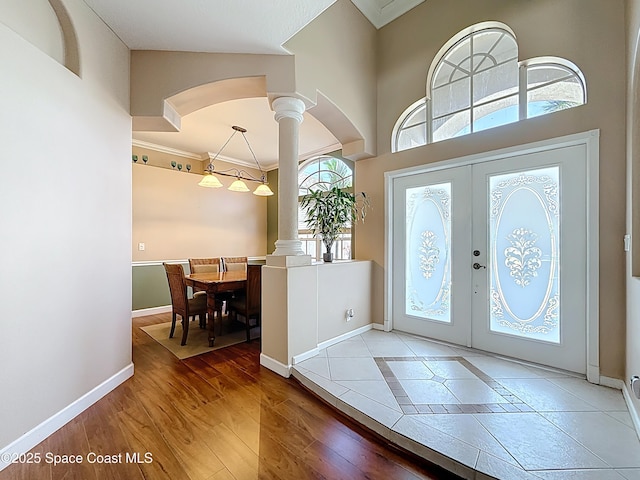 2050 SE Ellington Ter, Port St Lucie, FL 34952 - foyer entrance with ornate columns, baseboards, arched walkways, ornamental molding, and french doors