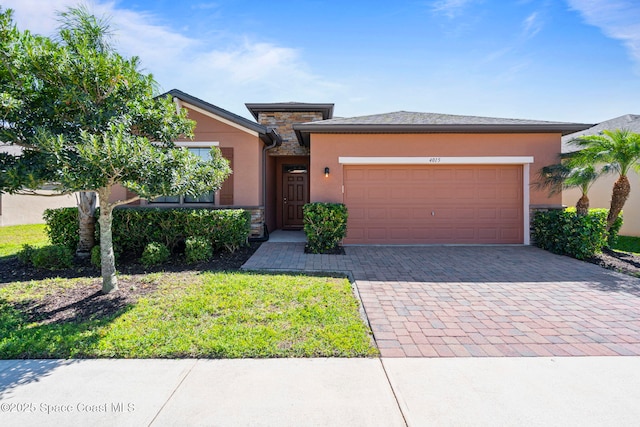 4015 Harvest Cir, Rockledge, FL 32955 - view of front of property with stucco siding, decorative driveway, a garage, and stone siding