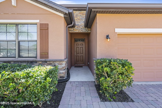 4015 Harvest Cir, Rockledge, FL 32955 - view of exterior entry with stucco siding, stone siding, and a garage