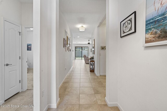 4015 Harvest Cir, Rockledge, FL 32955 - corridor with light tile patterned floors and baseboards