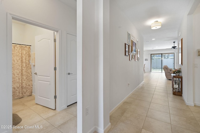 4015 Harvest Cir, Rockledge, FL 32955 - hall featuring light tile patterned flooring and baseboards