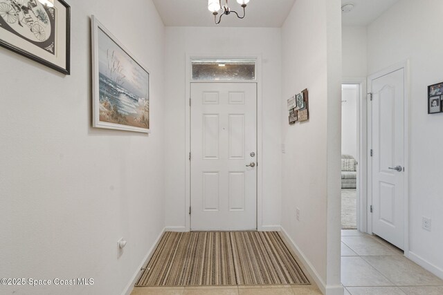 4015 Harvest Cir, Rockledge, FL 32955 - entrance foyer featuring a chandelier, light tile patterned flooring, and baseboards