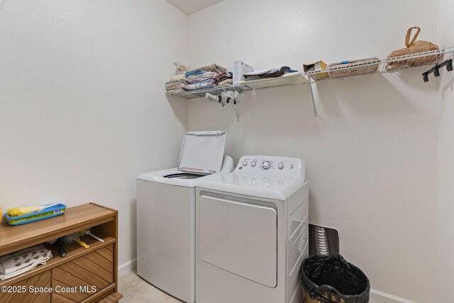4015 Harvest Cir, Rockledge, FL 32955 - laundry room featuring washing machine and dryer and baseboards