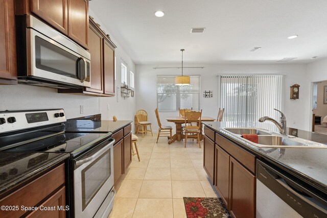 4015 Harvest Cir, Rockledge, FL 32955 - kitchen featuring stainless steel appliances, a sink, pendant lighting, recessed lighting, and brown cabinets