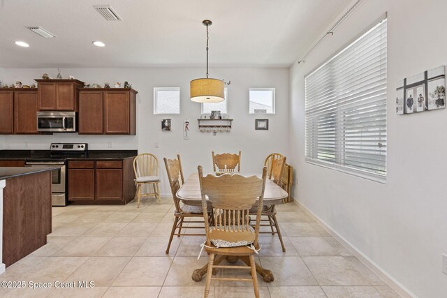 4015 Harvest Cir, Rockledge, FL 32955 - dining area with light tile patterned flooring, baseboards, and recessed lighting