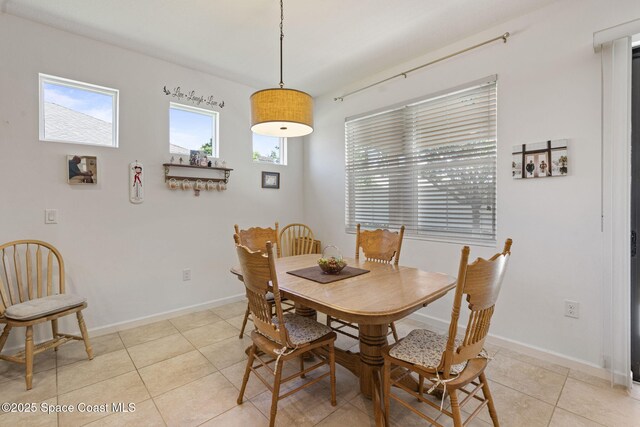 4015 Harvest Cir, Rockledge, FL 32955 - dining area featuring light tile patterned floors and baseboards