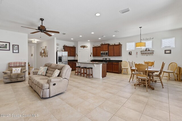 4015 Harvest Cir, Rockledge, FL 32955 - living room featuring recessed lighting, light tile patterned floors, and a ceiling fan