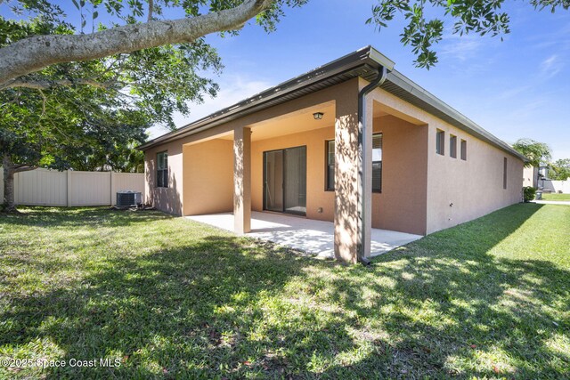 4015 Harvest Cir, Rockledge, FL 32955 - rear view of house with stucco siding, central air condition unit, and a patio