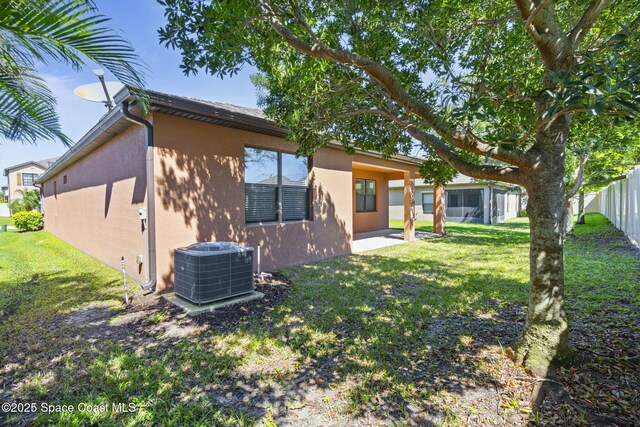 4015 Harvest Cir, Rockledge, FL 32955 - rear view of property featuring stucco siding, cooling unit, and a patio