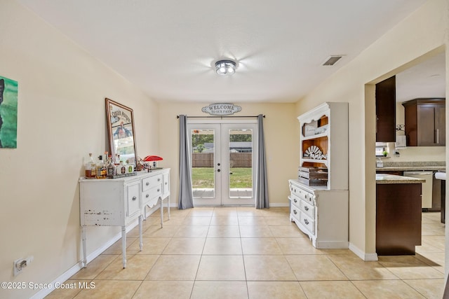 946 Stage St SE, Palm Bay, FL 32909 - foyer with french doors, light tile patterned floors, and baseboards