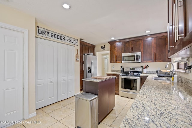 946 Stage St SE, Palm Bay, FL 32909 - kitchen with appliances with stainless steel finishes, a sink, a kitchen island, recessed lighting, and light tile patterned floors