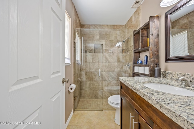 946 Stage St SE, Palm Bay, FL 32909 - bathroom featuring a shower stall, toilet, vanity, and tile patterned flooring