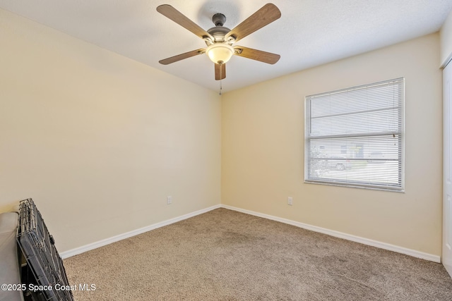 946 Stage St SE, Palm Bay, FL 32909 - empty room with carpet flooring, baseboards, and a ceiling fan