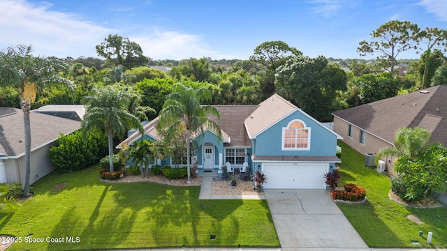4070 Orion Way, Rockledge, FL 32955 - view of front of house featuring concrete driveway, a front lawn, a garage, and central AC unit