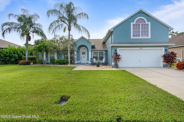 4070 Orion Way, Rockledge, FL 32955 - view of front of home featuring stucco siding, a garage, driveway, and a front yard
