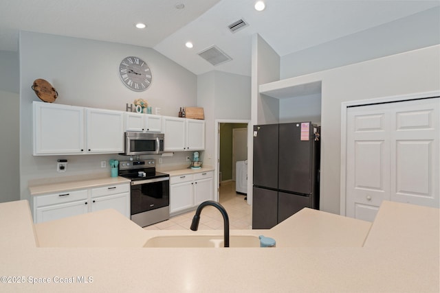 4070 Orion Way, Rockledge, FL 32955 - kitchen with appliances with stainless steel finishes, white cabinets, a sink, high vaulted ceiling, and light countertops