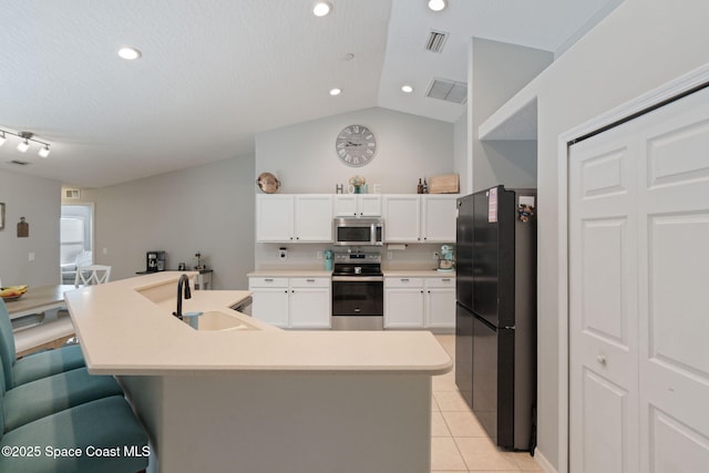 4070 Orion Way, Rockledge, FL 32955 - kitchen featuring appliances with stainless steel finishes, a sink, light tile patterned flooring, white cabinetry, and light countertops