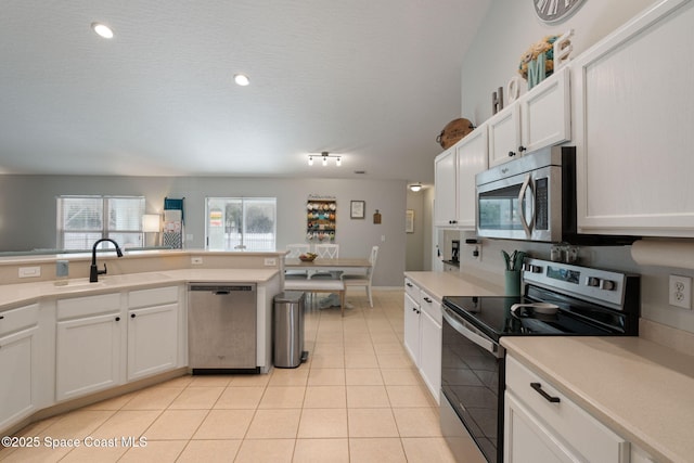 4070 Orion Way, Rockledge, FL 32955 - kitchen with appliances with stainless steel finishes, a sink, light tile patterned floors, light countertops, and white cabinets