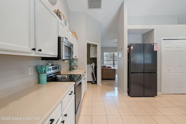 4070 Orion Way, Rockledge, FL 32955 - kitchen with stainless steel appliances, white cabinetry, light countertops, and light tile patterned flooring