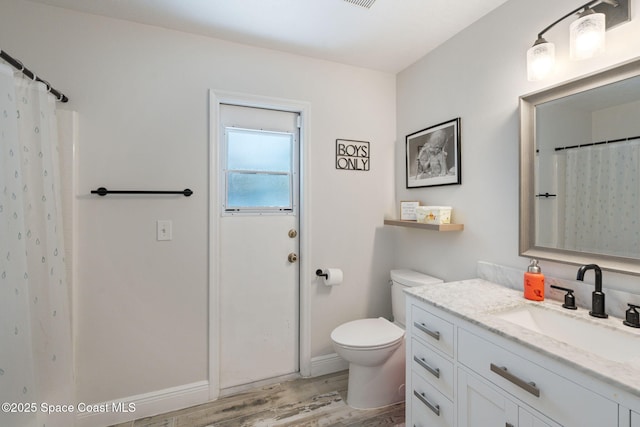 4070 Orion Way, Rockledge, FL 32955 - full bathroom with vanity, wood finished floors, toilet, and baseboards