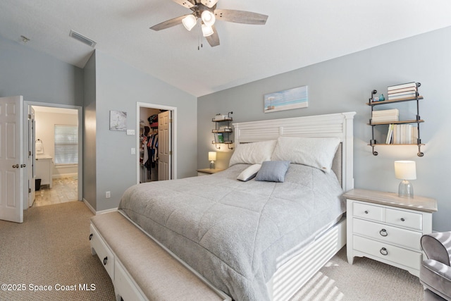 4070 Orion Way, Rockledge, FL 32955 - bedroom with carpet, vaulted ceiling, a walk in closet, a closet, and connected bathroom