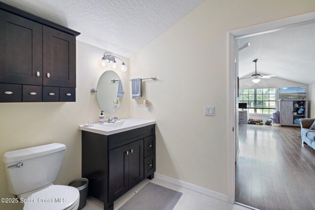 4070 Orion Way, Rockledge, FL 32955 - bathroom with vaulted ceiling, a textured ceiling, vanity, toilet, and a ceiling fan