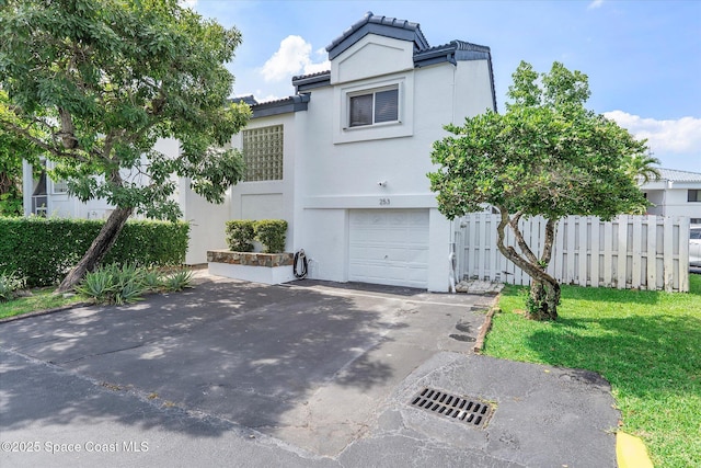 253 NE 212th Ter, Miami, FL 33177 - view of front facade with stucco siding, an attached garage, driveway, and a tile roof