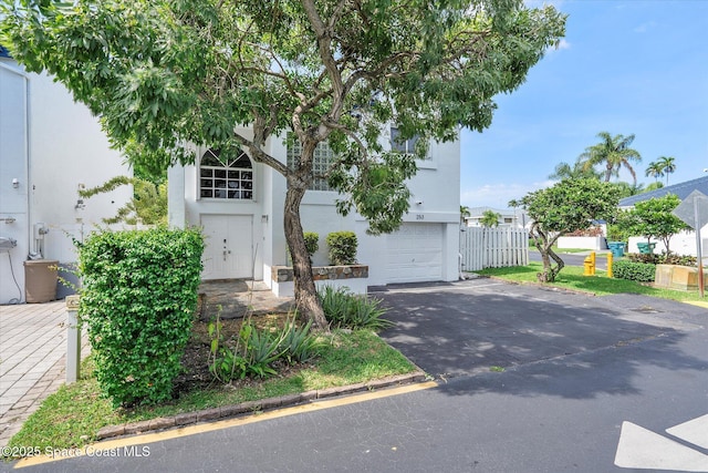 253 NE 212th Ter, Miami, FL 33177 - view of front of property featuring asphalt driveway, stucco siding, and an attached garage