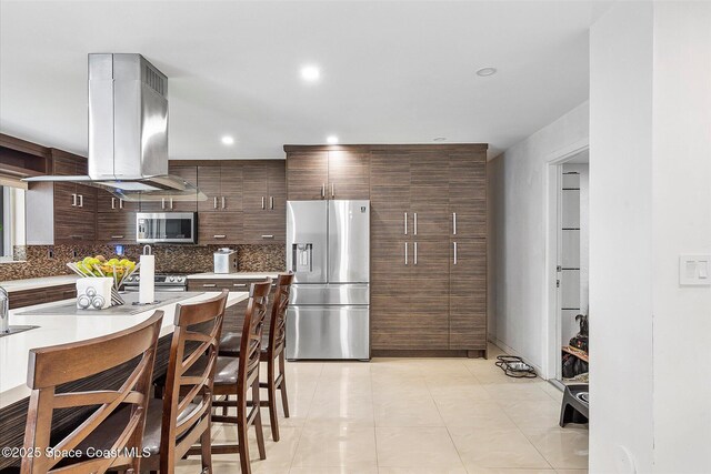253 NE 212th Ter, Miami, FL 33177 - kitchen with appliances with stainless steel finishes, island exhaust hood, modern cabinets, decorative backsplash, and recessed lighting
