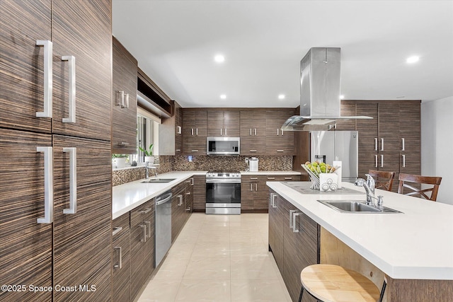 253 NE 212th Ter, Miami, FL 33177 - kitchen featuring appliances with stainless steel finishes, island range hood, a sink, modern cabinets, and recessed lighting