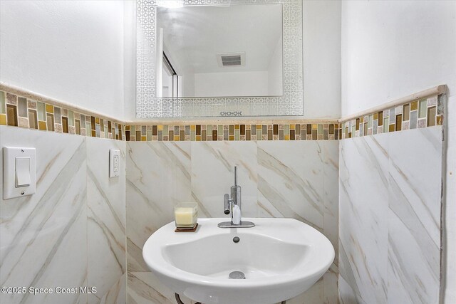 253 NE 212th Ter, Miami, FL 33177 - bathroom with tile walls and a sink