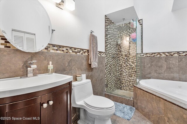 253 NE 212th Ter, Miami, FL 33177 - bathroom featuring tile walls, a stall shower, a garden tub, vanity, and toilet