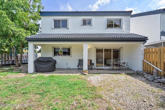 253 NE 212th Ter, Miami, FL 33177 - rear view of property featuring stucco siding, a tile roof, and a wooden deck