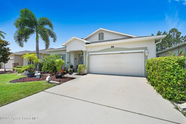 2263 Chinaberry Cir SE, Palm Bay, FL 32909 - ranch-style home with concrete driveway, a garage, stucco siding, and a front yard