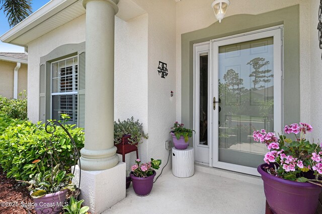 2263 Chinaberry Cir SE, Palm Bay, FL 32909 - doorway to property with stucco siding