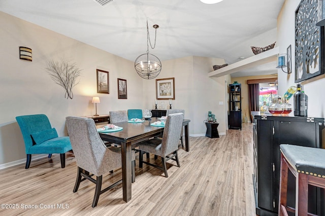 2263 Chinaberry Cir SE, Palm Bay, FL 32909 - dining space with light wood-type flooring, a chandelier, and baseboards