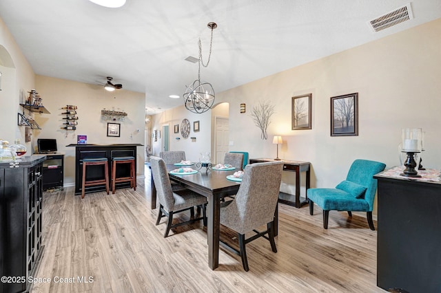 2263 Chinaberry Cir SE, Palm Bay, FL 32909 - dining area featuring light wood-style floors, arched walkways, baseboards, ceiling fan, and recessed lighting