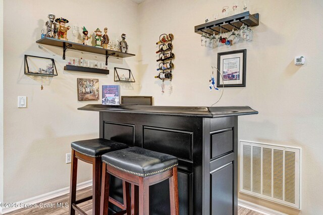 2263 Chinaberry Cir SE, Palm Bay, FL 32909 - indoor dry bar featuring baseboards and wood finished floors