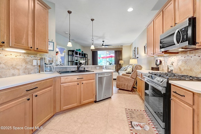 2263 Chinaberry Cir SE, Palm Bay, FL 32909 - kitchen with appliances with stainless steel finishes, a sink, a peninsula, open floor plan, and backsplash