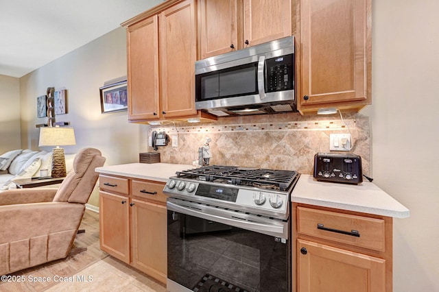 2263 Chinaberry Cir SE, Palm Bay, FL 32909 - kitchen with stainless steel appliances, open floor plan, light countertops, backsplash, and light brown cabinets