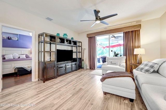 2263 Chinaberry Cir SE, Palm Bay, FL 32909 - living room featuring light wood-type flooring and ceiling fan
