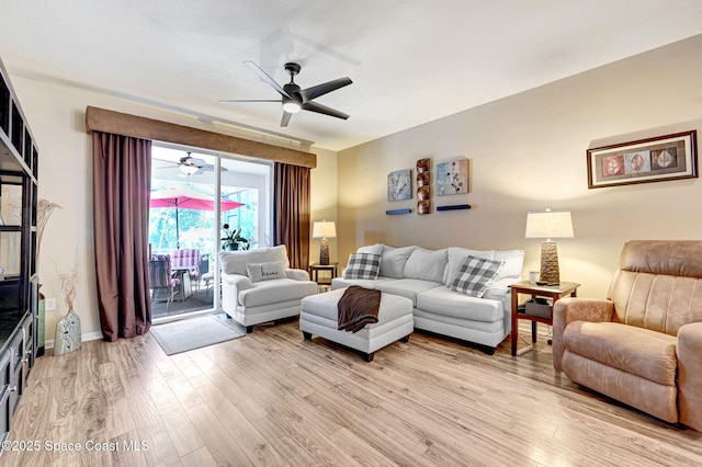 2263 Chinaberry Cir SE, Palm Bay, FL 32909 - living area featuring a ceiling fan, light wood finished floors, and baseboards