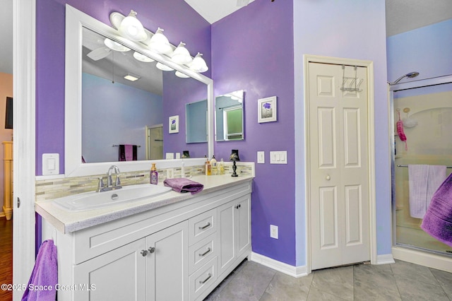 2263 Chinaberry Cir SE, Palm Bay, FL 32909 - full bath with vanity, a stall shower, baseboards, and tile patterned flooring