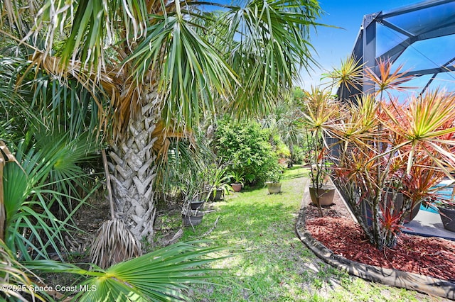 2263 Chinaberry Cir SE, Palm Bay, FL 32909 - view of green lawn featuring glass enclosure