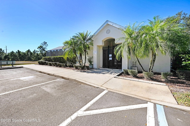 2263 Chinaberry Cir SE, Palm Bay, FL 32909 - view of front facade featuring stucco siding and uncovered parking