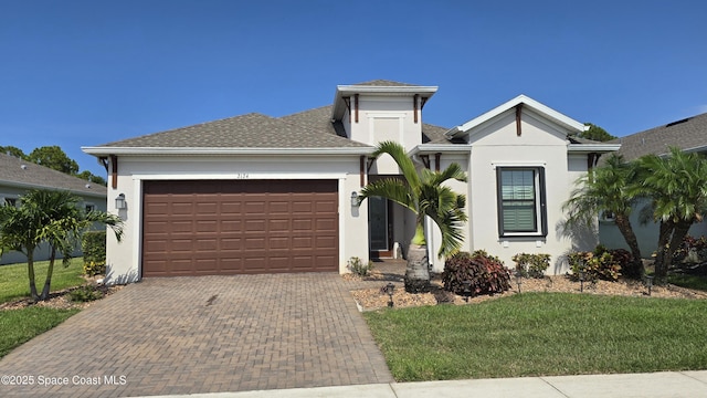 2124 Trift Bridge Cir, Melbourne, FL 32940 - view of front facade with a garage, decorative driveway, stucco siding, and a front lawn